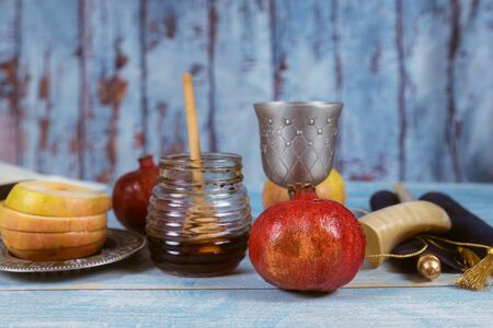Jewish Holiday Rosh hashanah honey and apples with pomegranate traditional symbolsの写真素材