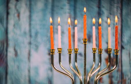 Colorful candles from a burning hanukkah candles in a menorahの写真素材