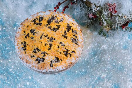 Christmas blueberry pie with snowflakes on frosty snow.の写真素材
