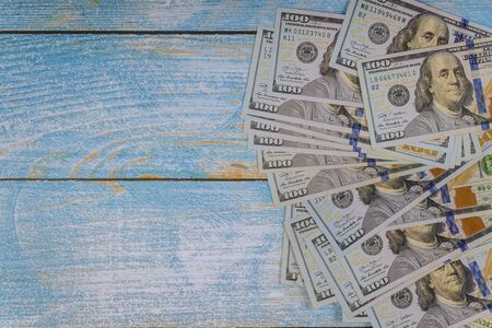 One hundred dollars on a blue background. One hundred dollar bills.の写真素材