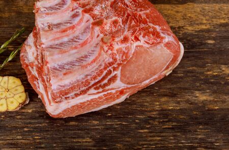 Tenderloin pork with ribs on wooden dark background.の写真素材