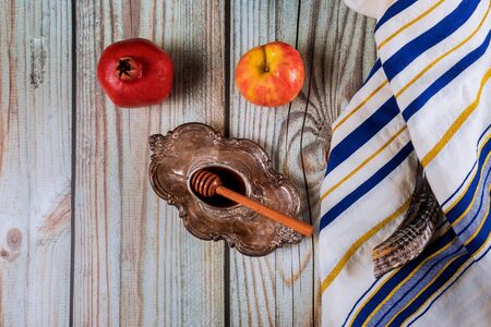 A jewish new year with honey for the apple and pomegranate holiday of Yom Kippur and Rosh Hashanah Jewish praysの写真素材