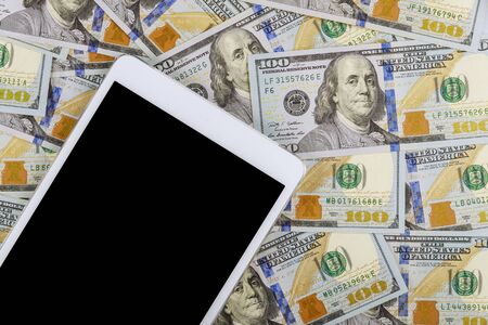 American banknotes hundred dollar bills on digital devices tablet with financial currency e-commerce...