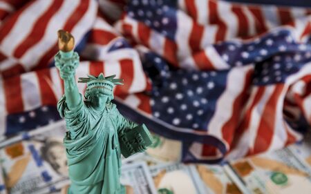 The Statue of Liberty the United States a symbol of freedom and democracy with flag of the United States of America US dollar billsの写真素材