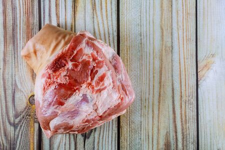 Fresh raw pork leg on wooden cutting boardの写真素材