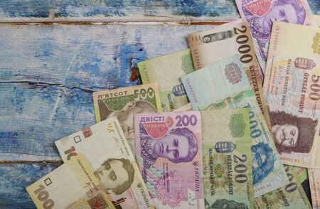 Macro close-up Hungarian forint banknotes and Ukrainian hryvnias currency moneyの写真素材