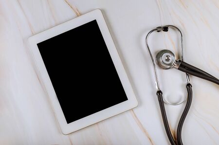 Digital tablet computer with medical stethoscope on marble table on the workplace medical hospital officeの写真素材