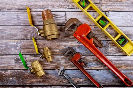 Monkey wrench brass plumbing fittings and level tape on gate ball vales construction concept.の写真素材