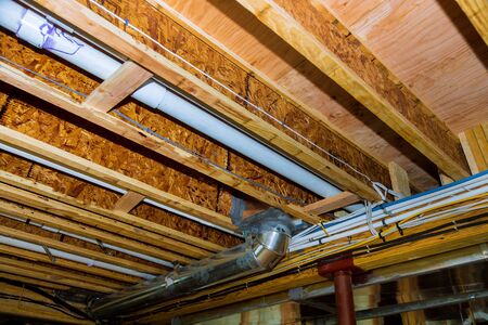 Interior wall framing electric with piping and wiring installed in the basement of house under remodelingの写真素材