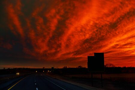 Autumn road sunset, the rays of light in the car the road under sunbeams