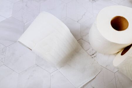 Rolls of toilet paper with white tiles background in bathroom