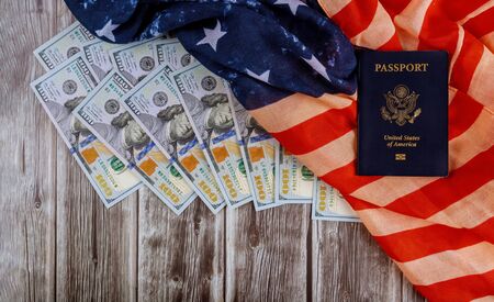 American passports and flag with the symbols of the United States of America and USA currency hundred US dollar billsの写真素材