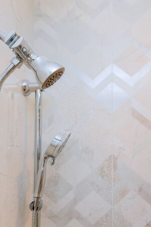 Close up on head shower running with water drops flowing