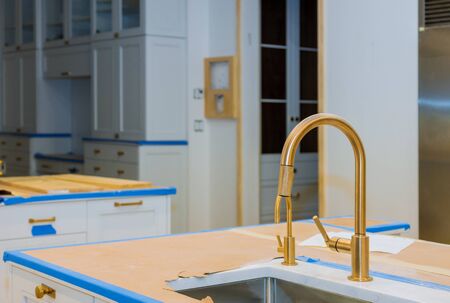 Modern domestic kitchen cabinets with new appliances and sink in kitchenの写真素材