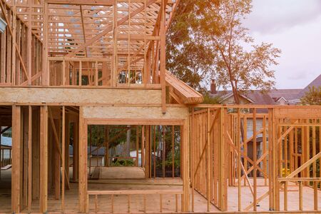 New construction of beam construction house framed the ground up framing against a blue skyの写真素材