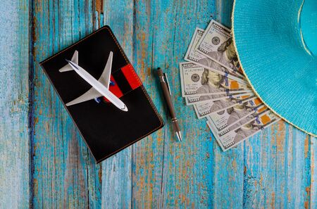 Travel planning airplane, pencil, blue hat and notebook pag with blank space preparation for traveling flat layの写真素材