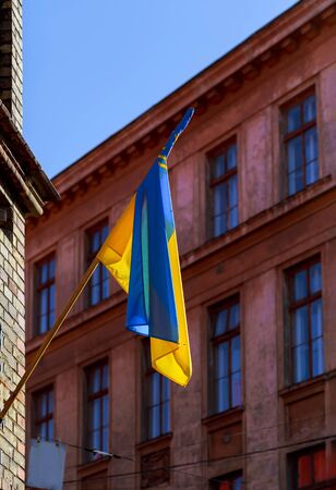 Ukrainian yellow blue flag waving on a flagpole of the building.の写真素材
