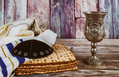 Passover Jewish holiday pesah celebration matzah bread and kosher wine with kipah and tallitの写真素材