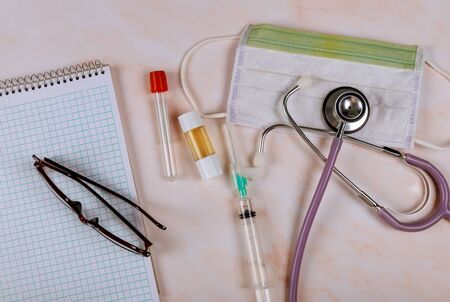 Medical equipment in glasses over notebook with phonendoscope health care professional occupation