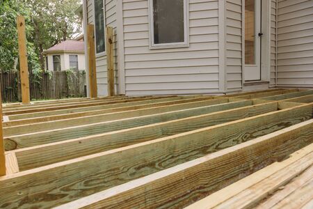Building a patio with wooden porch terrace flooring in patio outside the new houseの写真素材