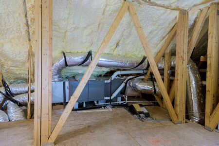 Air conditioning system attached to attic thermal foam plastic insulation new home installation of...