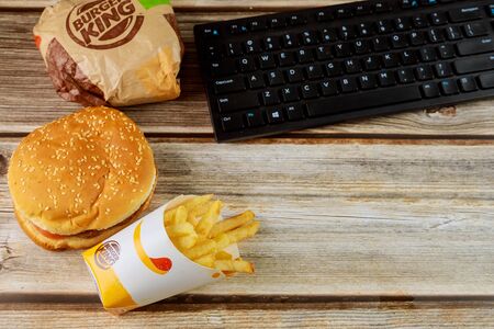 17 January 2020 Chicago IL: Burger king set has hamburger french fries on wooden tableのeditorial素材