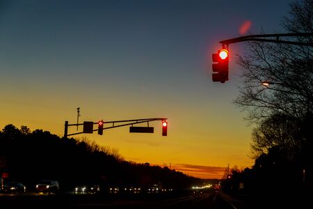 Cars stuck in traffic at dramatic sundown sunset time soft focus