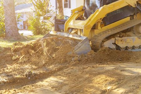 Close up of bulldozer scoop moving earth in preparation landscaping works