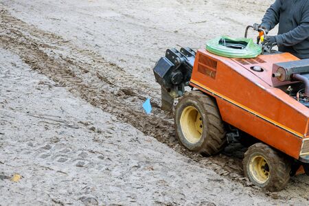 Tractor used for pipeline earthworks a digging a ground earth with garden on ground for irrigation...