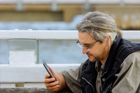 Technology, communication man with smartphone on street against of the bay