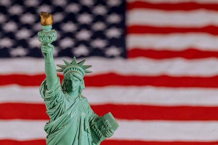 Liberty statue in closeup of grunge American flag NEW YORK, NY USAの写真素材