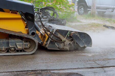 Removing old asphalt from a street surface road milling machine layers at full depth