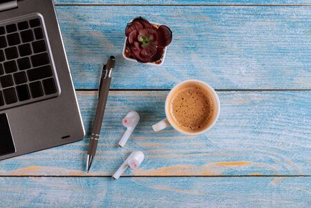 Electronic devices for business on work table on laptop, tablet with wireless headphones cup of coffeeの写真素材
