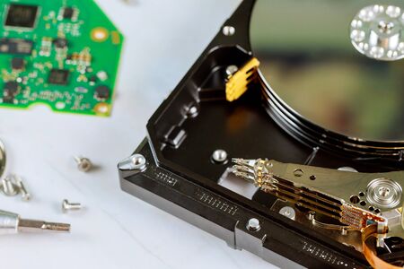 Disassembled a broken hard disk drive to repair support centerの写真素材