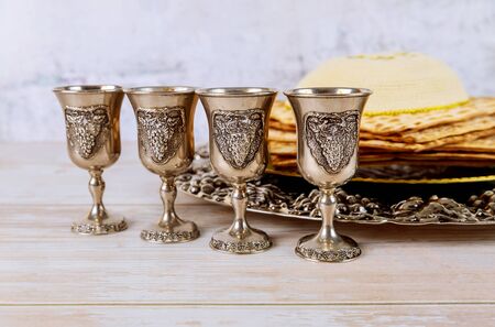 Matzoh jewish passover bread in the traditional seder plate over wooden table