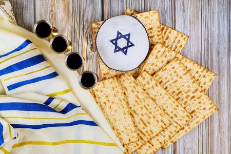Matzoh jewish holiday red kosher four glasses wine with a of matzah a Passover Haggadahの写真素材