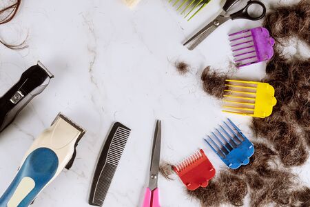 Hair electric trimmer with accesories with pile of cut hairの写真素材