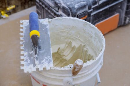 Trowel mortar tIling a closeup with new cement trowel ceramic tiles.の写真素材