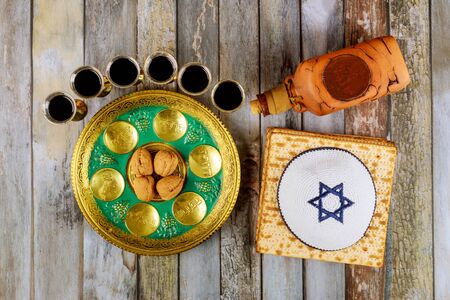 Passover Jewish matzah, kiddush with wine and seder with text in hebrew egg, bone, herbs, karpas, chazeret and charoset.の写真素材