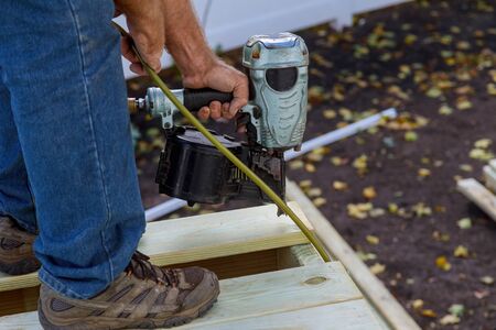 Installing wood floor for patio deck with new wooden decking fragment planksの写真素材