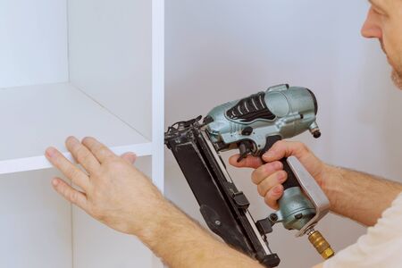 Assembling shelves for closet cabinet with home a new apartment wall installing a shelfの写真素材