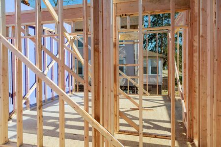 Wood building frame structure on a new development framing of a new house under constructionの写真素材