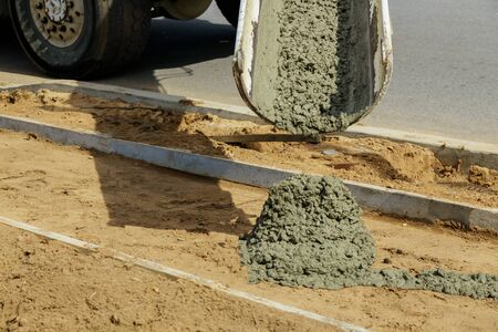 Concrete truck with pouring cement during to residential street selective focusの写真素材