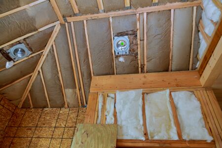 New frame house of fiberglass cold barrier insulation material in the sloping attic