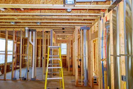 Framed residential home with basic rough plumbing completed in new constructionの写真素材