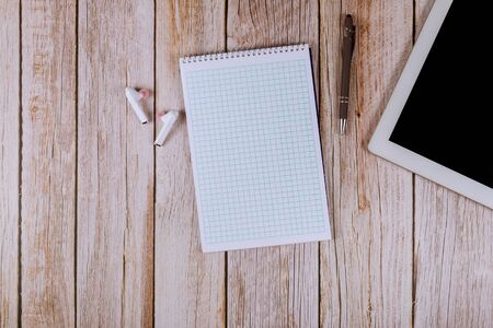 Business of office table with notebook on touch screen device, pen wireless headphones on wooden tableの写真素材