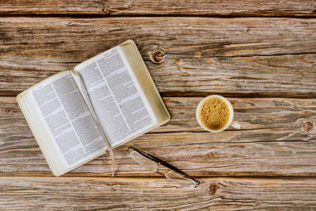Los Angeles CA US 16 MAY 2020: Open Holy Bible morning readings on a table top with coffee cup and eyeglassesのeditorial素材