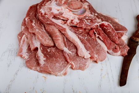Piece of fresh juicy raw cutting meat on chopping boardの写真素材
