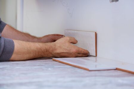 Working tile grouting applying joint tiles for home improvements to a kitchen