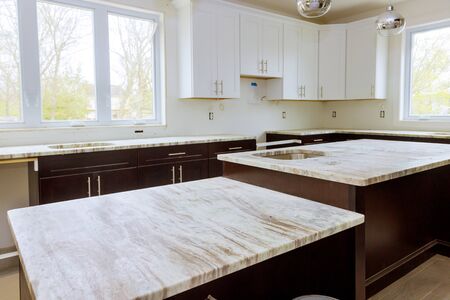 Home improvement and interior design new white kitchen renovation installing cabinets and counter...